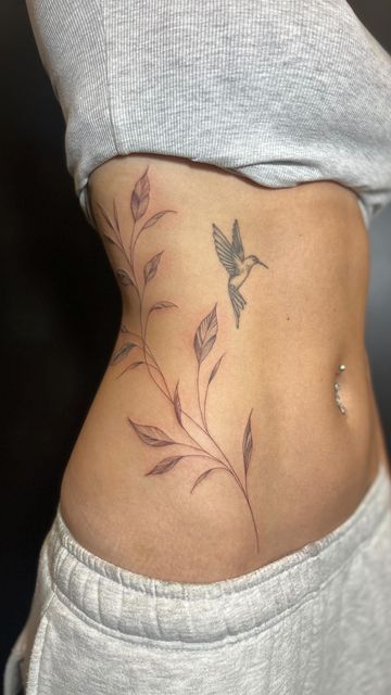 Elegant Watercolor Rib Tattoo with Hummingbird