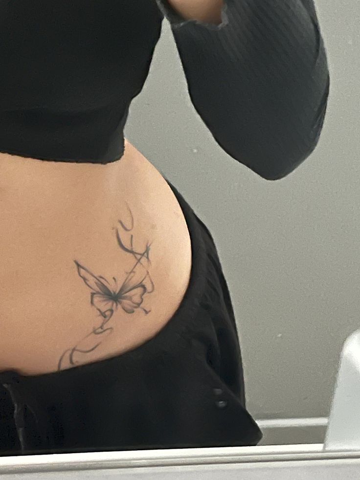 elegant butterfly rib tattoo