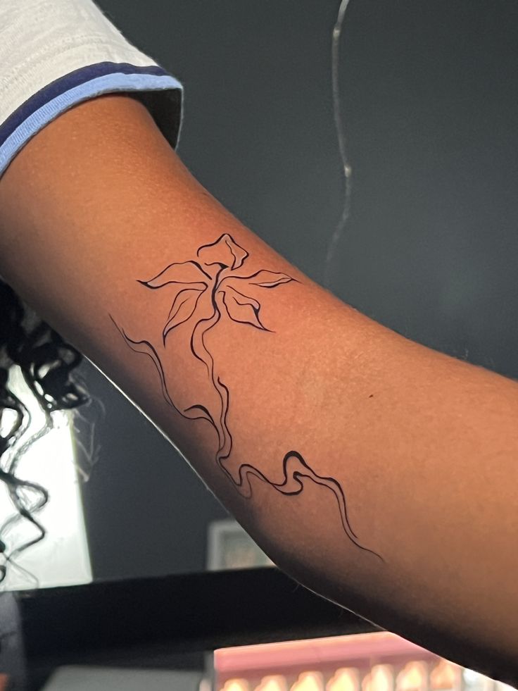 elegant minimalist floral tattoo
