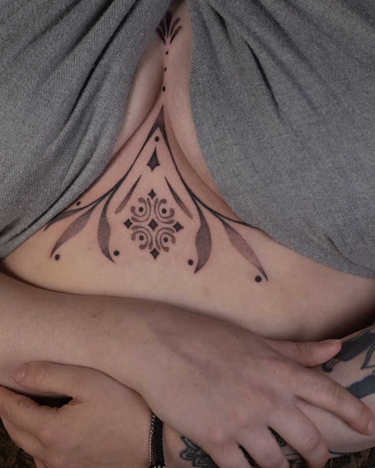 Elegant Ornamental Sternum Tattoo Design