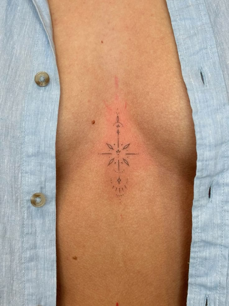 Elegant Fineline Ornamental Sternum Tattoo Idea