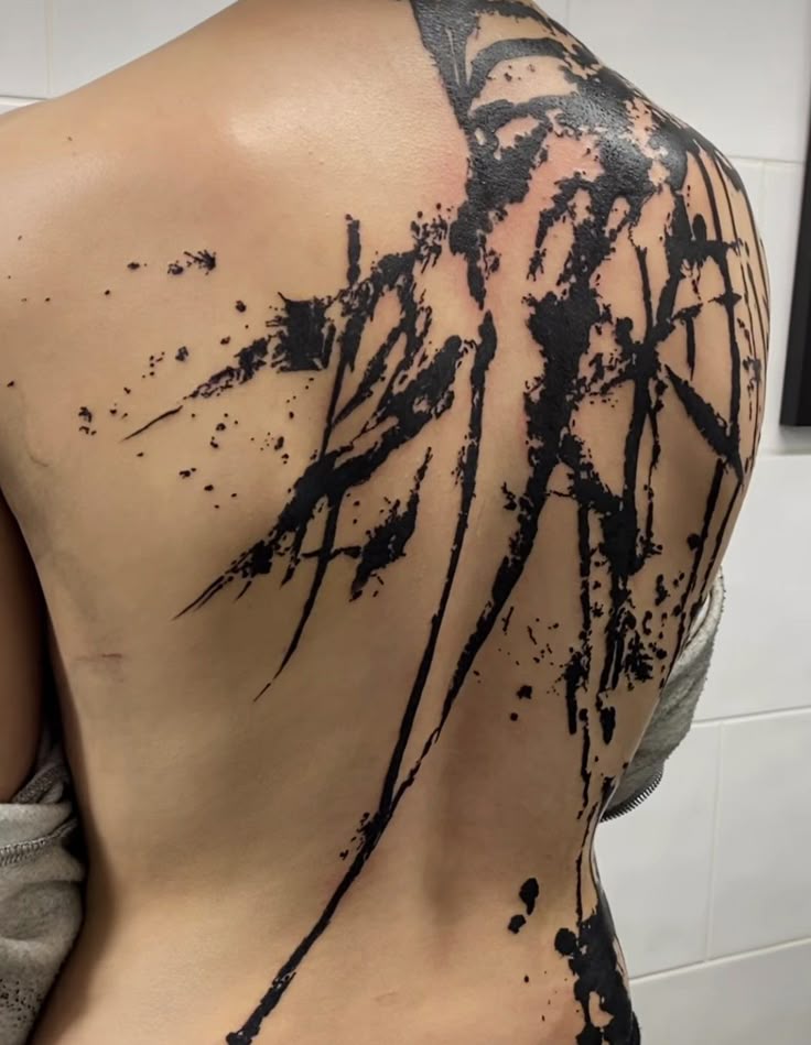 bold abstract splatter back tattoo
