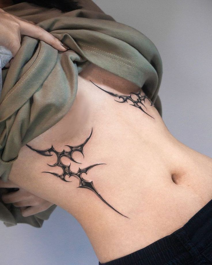 Empowering Tribal Ribcage Tattoo Design