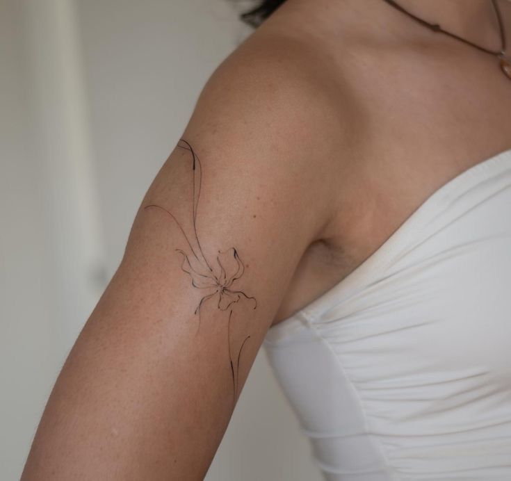 Delicate Minimalist Flower Tattoo for the Upper Arm