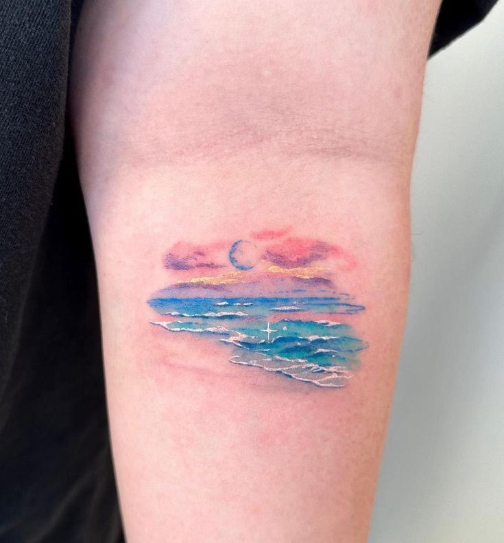 Serene Ocean Sunset Watercolor Tattoo